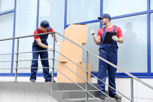A removals team loading furniture from a Queens Park flat