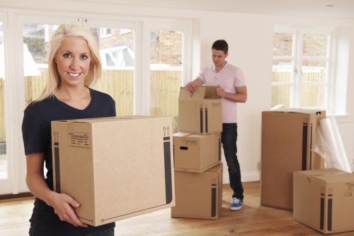 Packing and organising moving boxes in a Queens Park home