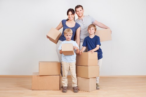 Packed household items and moving equipment for Queens Park flat removals
