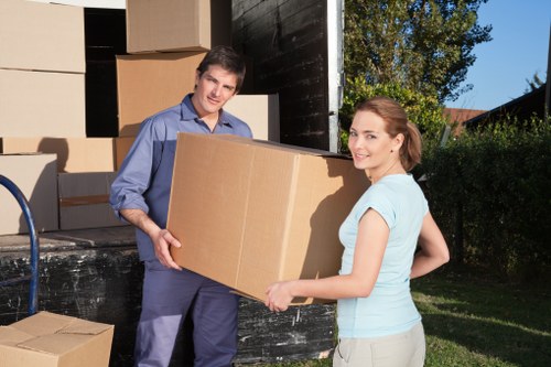 Professional movers handling business items during a Queens Park move
